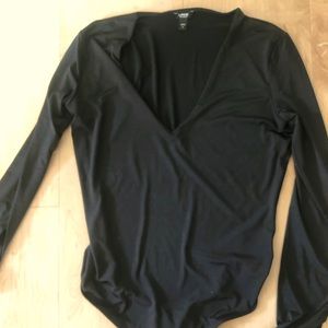 Long sleeve body contour thong bodysuit.